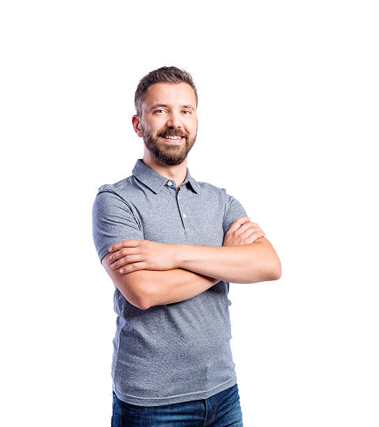 Ideal Pose Young handsome hipster man in gray t-shirt, arms crossed, studio shot on white background, isolated